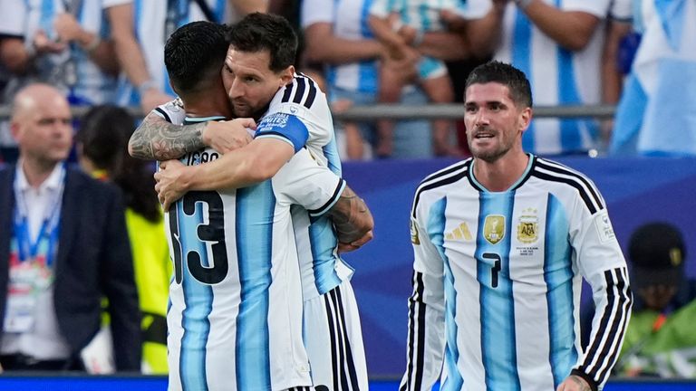 Argentina's Lionel Messi is congratulated by teammate Cristian Romero