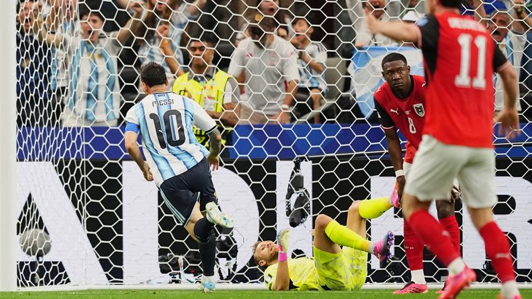 Argentina's Lionel Messi, left, runs celebrating after scoring the opening goal during the World Cup Group J match against Austria