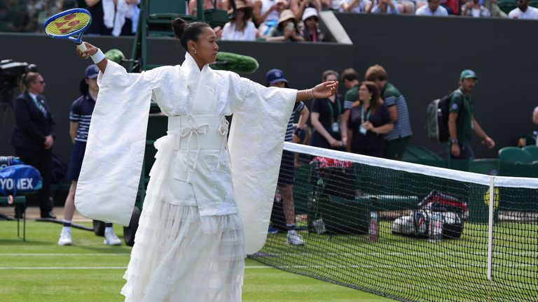 Naomi Osaka of Japan walks into the court to play against Elsa Jacquemot of France in their first round women's singles match at the Wimbledon Tennis Championships in London, Monday, June 29, 2026. (AP Photo/Maja Smiejkowska)