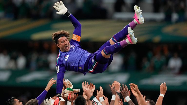 Mexico goalkeeper Guillermo Ochoa is thrown into the air by his teammates
