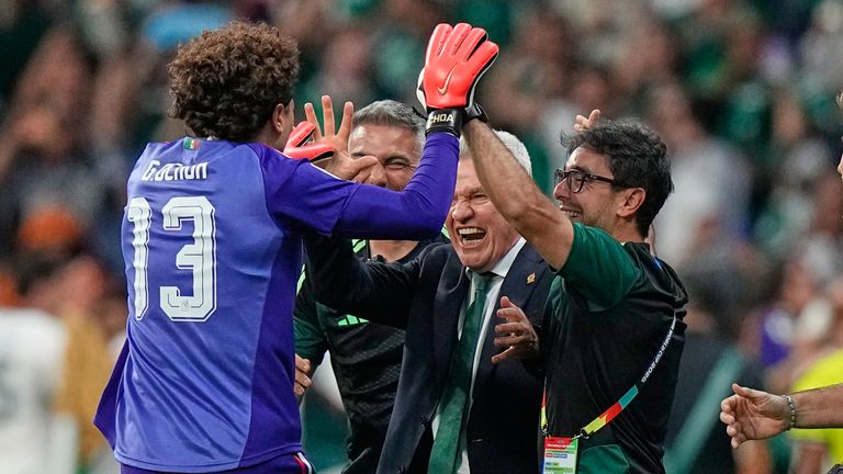 Ochoa celebrates with Mexico head coach Javier Aguirre after scoring the third goal