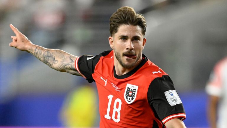 Austria's Romano Schmid (18) celebrates after scoring their opening goal during the World Cup Group J soccer match