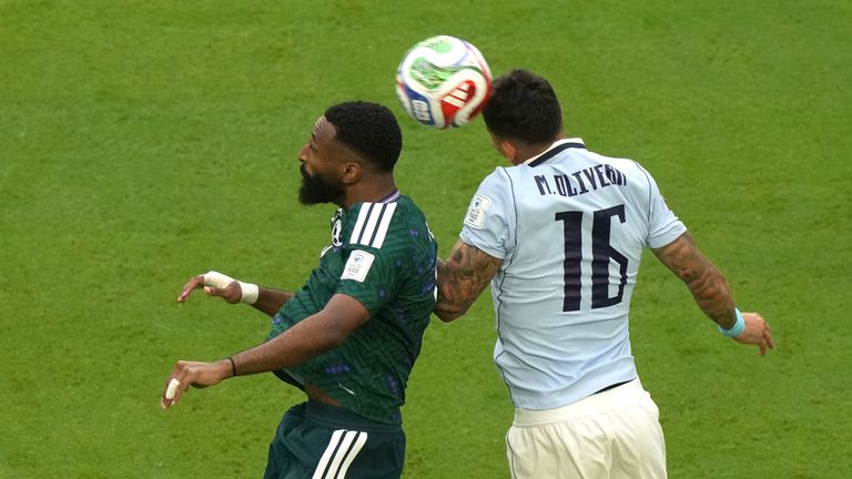 Saudi Arabia's Feras Albrikan (9) challenges for the ball with Uruguay's Mathias Olivera (16) during the World Cup Group H match in Miami