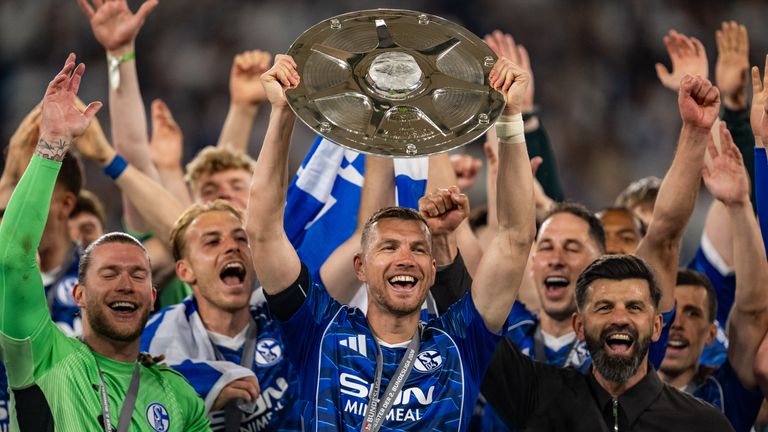 Schalke striker Edin Dzeko celebrates after winning the title with Schalke to help the club back to the Bundesliga