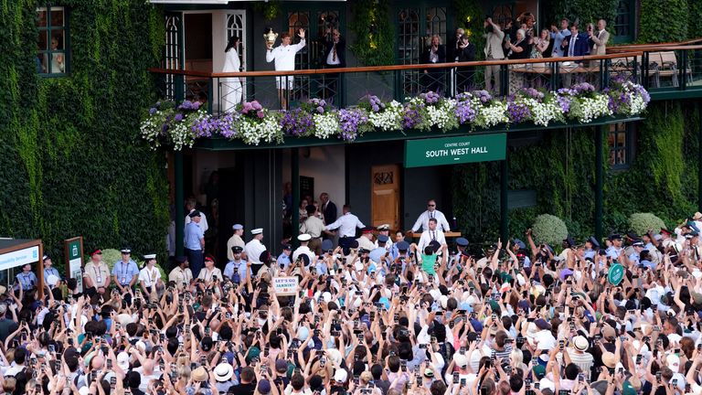 Jannik Sinner celebrates with the Wimbledon crowd after winning last year's title