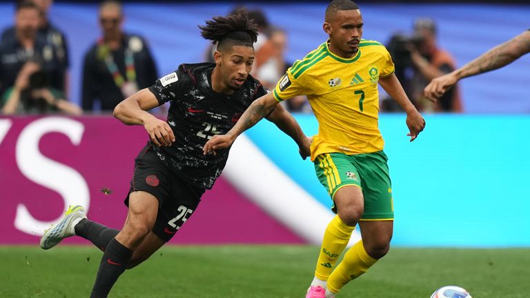 South Africa's Oswin Appollis and Canada's Nathan Saliba battle for the ball (AP Photo/Andre Penner)