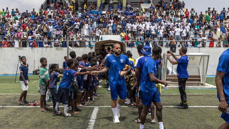 Cape Verde's midfielder Telmo Arcanjo greets supporters as he walks into the pitch ahead of a training session to prepare for the World Cup
