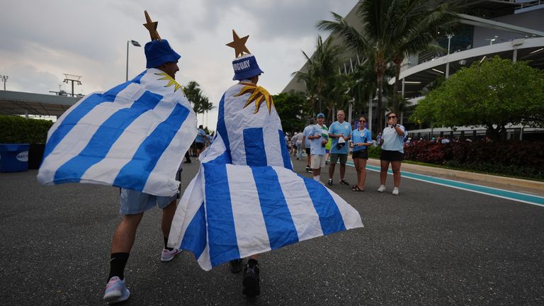 Uruguay fans wrapped in national flags arrive at the stadium ahead of their match against Saudi Arabia
