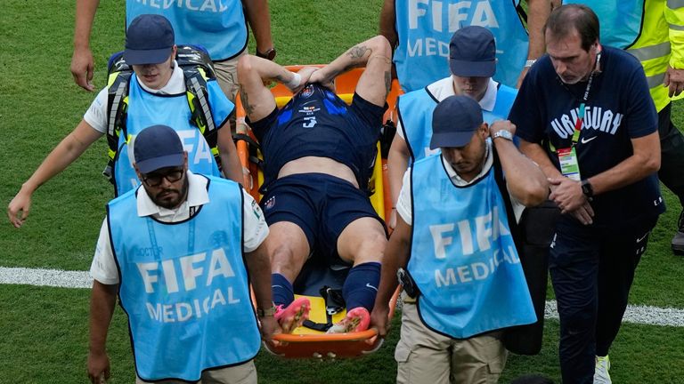 Manuel Ugarte is carried off the field on a stretcher after suffering an injury in Uruguay's clash with Spain