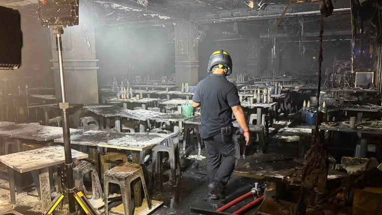 A Thai rescue official inside the pub in Lat Phrao, northern Bangkok, Thailand. Pic: Fire & Rescue Thailand