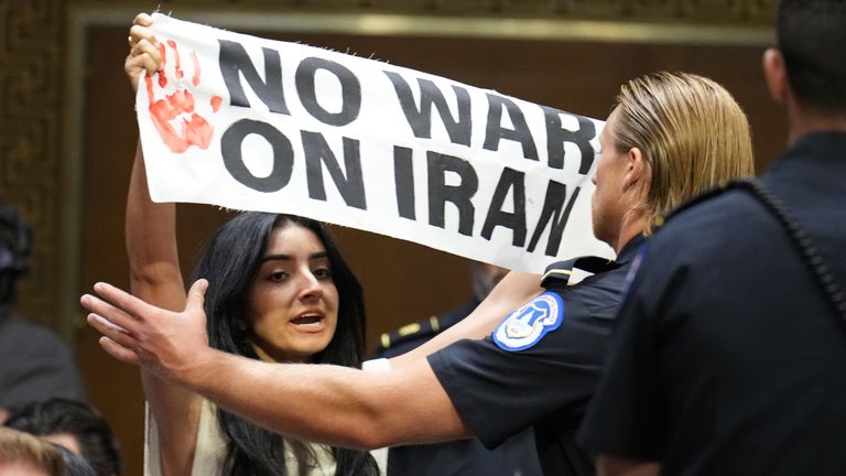 Police remove a protester. Pic: AP