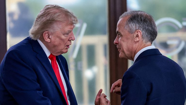 Donald Trump and Mark Carney talk at a G7 summit in June. Pic: AP