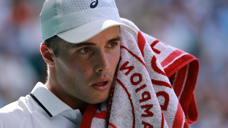 Arthur Fery of Great Britain wipes off sweat during the men's singles fourth round match against Grigor Dimitrov of Bulgaria on day eight of the 2026 Wimbledon Championships at All England Lawn Tennis and Croquet Club in London, on July 6, 2026. ( The Yomiuri Shimbun via AP Images )