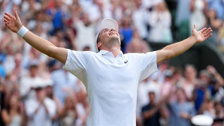 Arthur Fery holds his arms out in Jude Bellingham style celebration after coming through a five-set epic