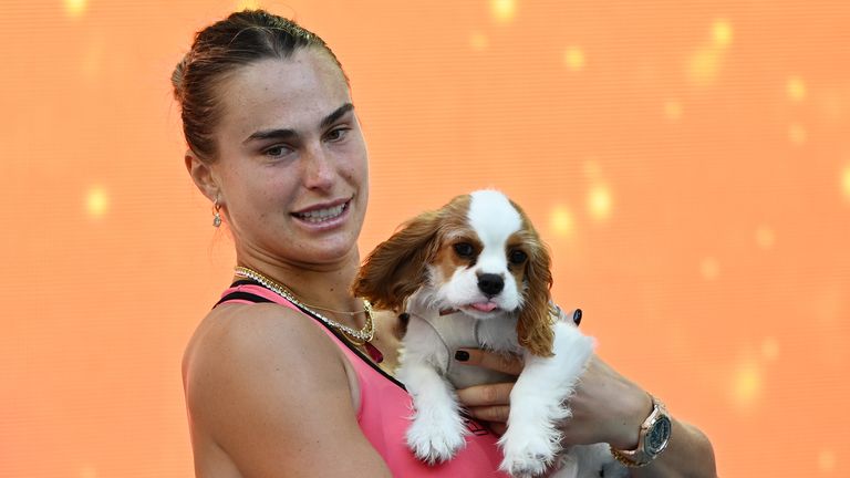 Aryna Sabalenka poses with the championship trophy and her dog Ash after defeating Coco Gauff during the women's final mpi04/MediaPunch /IPX