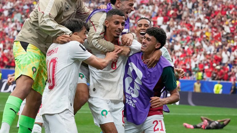 Morocco's Azzedine Ounahi is mobbed by team-mates after scoring second goal against Canada (AP Photo/David J. Phillip)