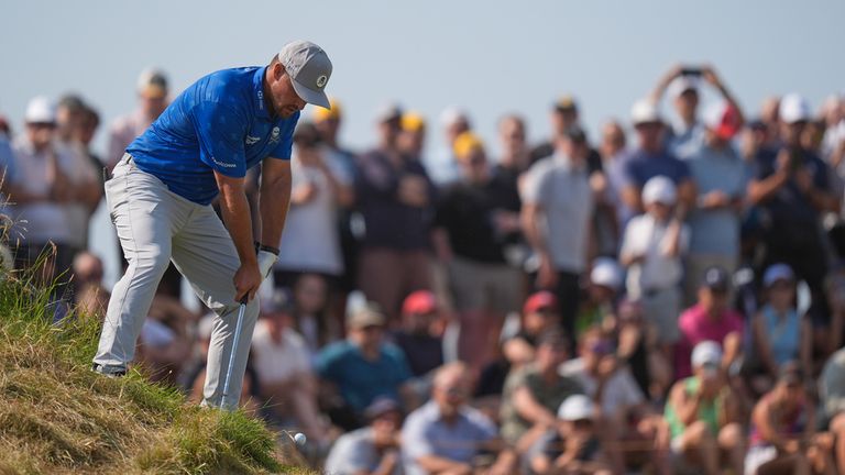 Bryson DeChambeau plays from an awkward lie to the fifth green