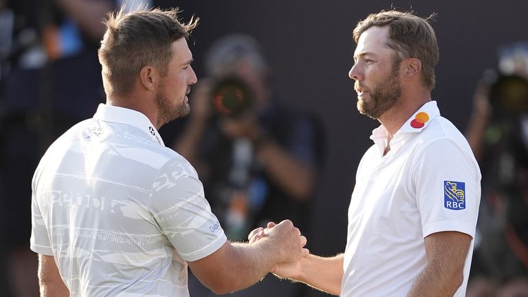 Sam Burns shakes hands with Bryson DeChambeau after the third round of The Open
