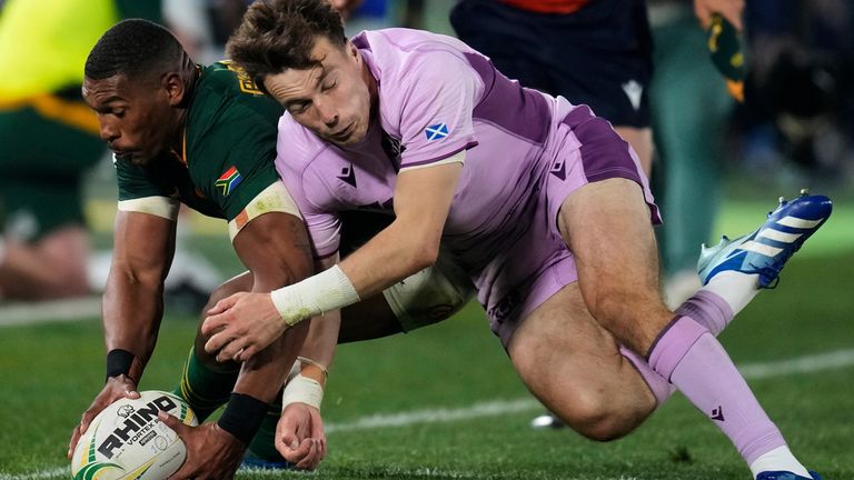South Africa's Damian Willemse, left, is tackled by Scotland's Jamie Dobie 