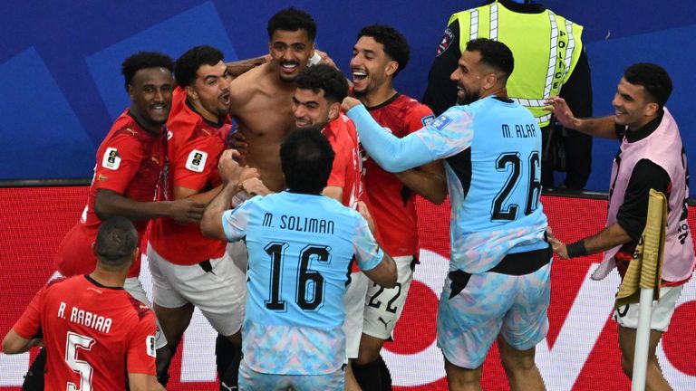 Egyptian players celebrate after winning a penalty shootout against Australia 