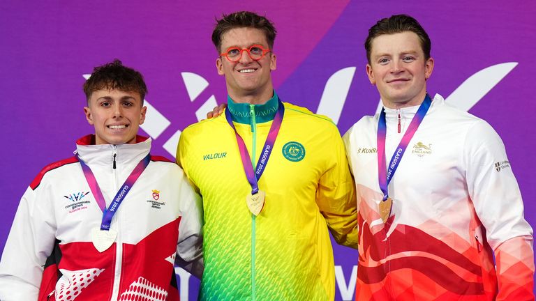 Jersey's Filip Nowacki, Australia's Sam Williamson and England's Adam Ramsay-Peaty, bronze, following the Men's 100m Breaststroke final