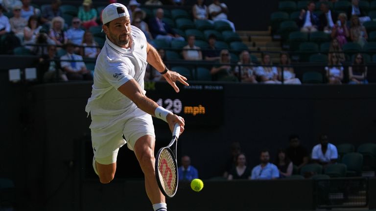 Grigor Dimitrov of Bulgaria returns the ball to Jakub Mensik of Czech Republic in their second round men's singles match at the Wimbledon Te