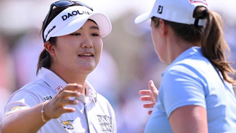 Haeran Ryu is congratulated by playing partner Lottie Woad after her record-breaking third round at the Evian Championship