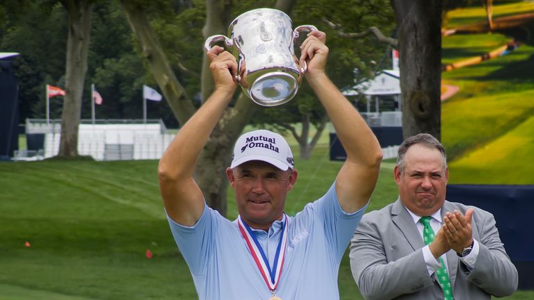 Padraig Harrington lifts up the Francis D. Ouimet Memorial Trophy after winning the U.S. Senior Open at Scioto Country Club