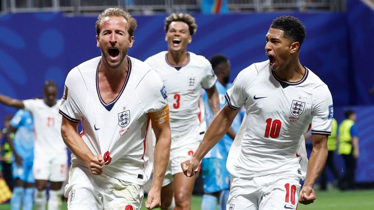 Harry Kane celebrates after with England team-mates after scoring their equaliser (AP Photo/Butch Dill)