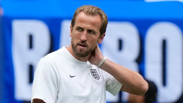 England's Harry Kane, left, and Dan Burn stand on the pitch prior to the World Cup third-place playoff soccer match between France England