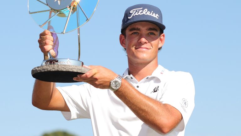 Jackson Koivun holds his trophy after winning the 3M Open golf tournament