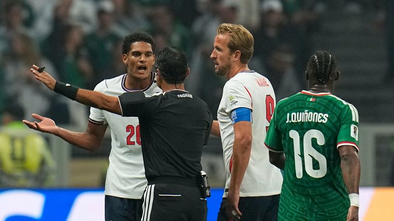England's Jarell Quansah reacts next to England's Harry Kane and referee Alireza Faghani after receiving a red card during the World Cup round of 16 soccer match between Mexico and England in Mexico City, Sunday, July 5, 2026. (AP Photo/Ricardo Mazalan)