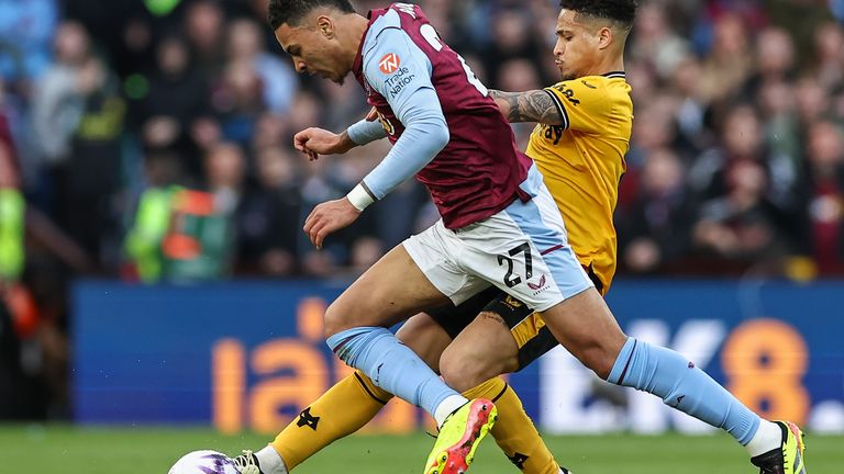 Wolves' Joao Gomes tackles Aston Villa's Morgan Rogers