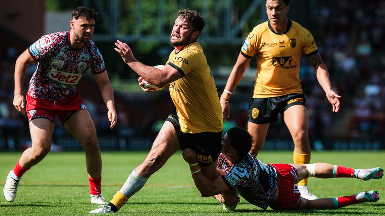 Joe Stimson of Castleford is tackled by David Armstrong of Leigh