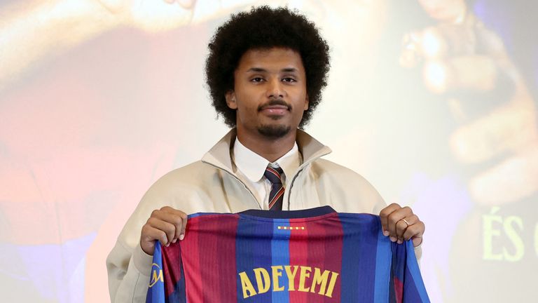 German footballer Karim Adeyemi poses with a jersey bearing his name during his official presentation as FC Barcelona's new player
