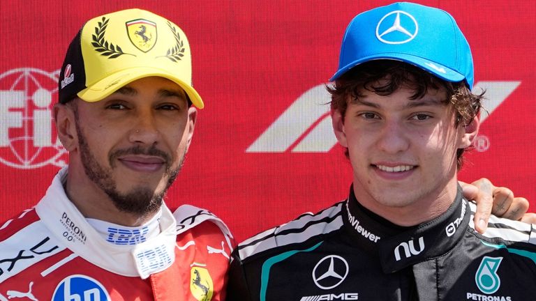 Race winner Mercedes driver Andrea Kimi Antonelli of Italy, center, poses with second placed Ferrari driver Lewis Hamilton of Britain, left, and third placed McLaren driver Lando Norris of Britain after the sprint race at the British F1 Grand Prix, in Silverstone, England, Saturday, July 4, 2026. (AP Photo/Darko Bandic)