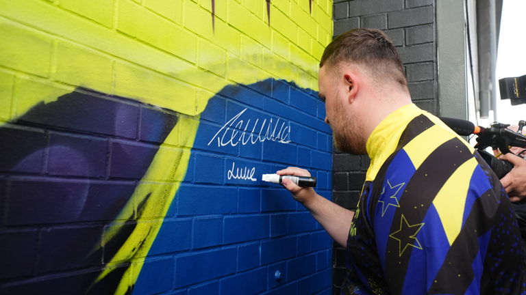 Luke Littler gave the mural its finishing touch