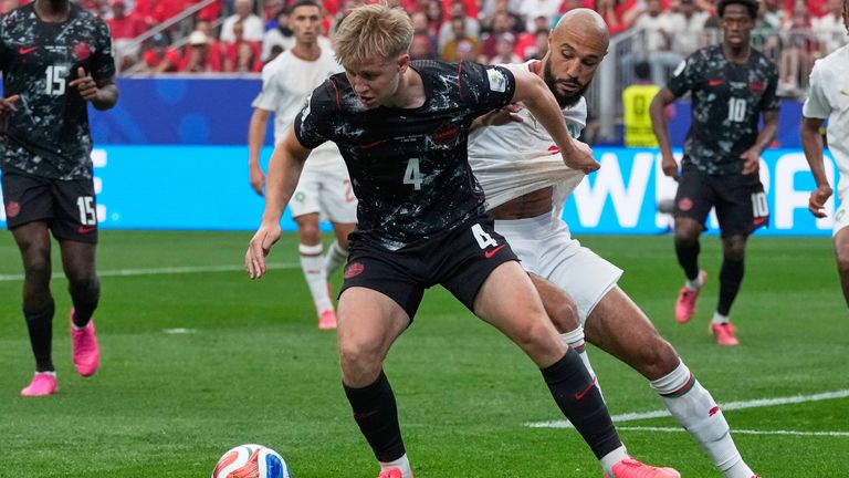 Canada's Luc de Fougerolles, front, and Morocco's Noussair Mazraoui battle for the ball (AP Photo/David J. Phillip)