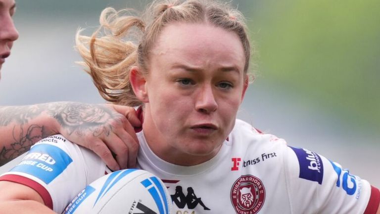 Wigan Warriors' Mary Coleman tries to break between two York Valkyrie players