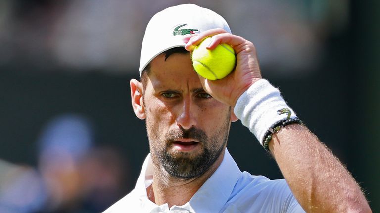 Novak Djokovic of Serbia serves against Arthur Rinderknech of France in their third round men's singles match at the Wimbledon Tennis Champi