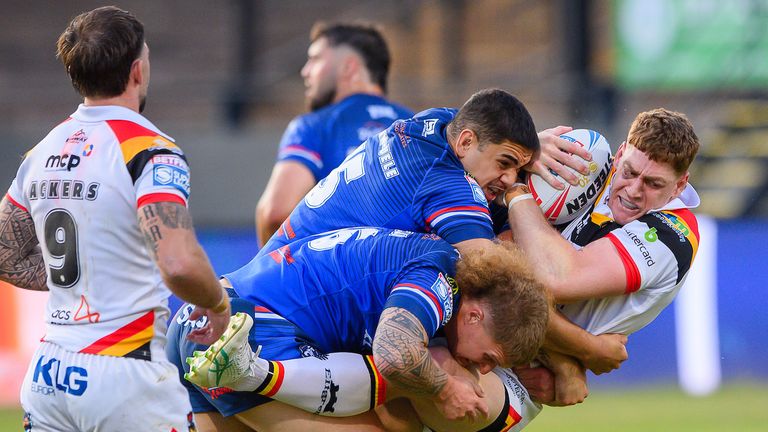 Picture by Allan McKenzie/SWpix.com - 16/07/2026 - Rugby League - Betfred Super League Round 19 - Bradford Bulls v Wakefield Trinity - Bartercard Odsal Stadium, Bradford, England - Bradford's Daniel Russell is tackled by Wakefield's Caleb Hamlin-Uele & Caius Faatili.