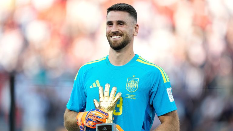 Spain goalkeeper Unai Simon poses with the Golden Glove award  (AP Photo/Ashley Landis)