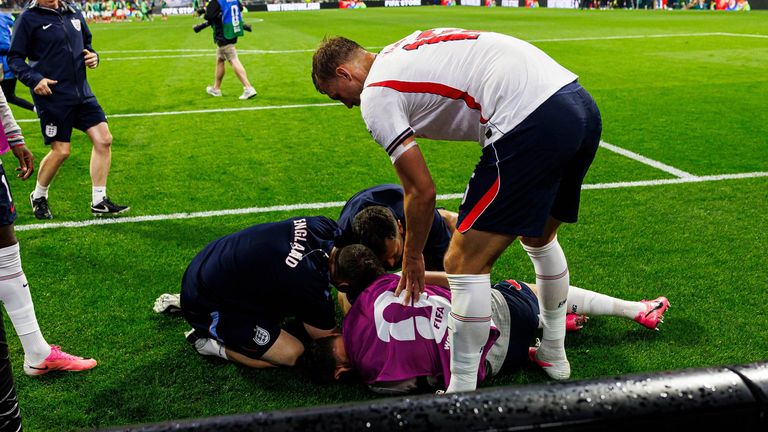 Jordan Henderson receives treatment after sustaining an injury during post-match celebrations following England's win over Mexico.