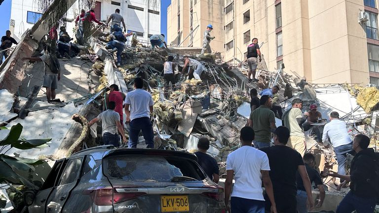 Residents dig through the debris of a collapsed building after an earthquake, in Cali, Colombia. Pic: Reuters
