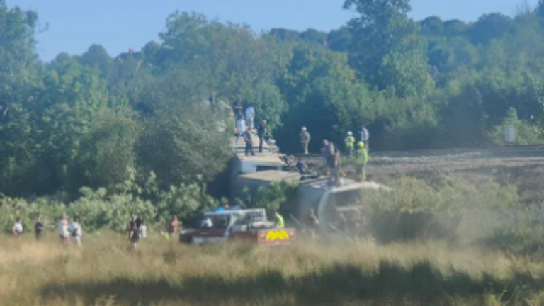 Image shows carriages on their side after train derails near Lewes train station. Credit: Laura Arnold