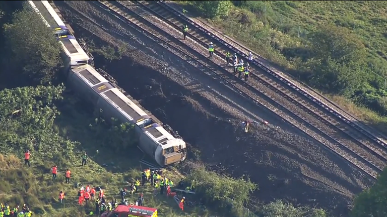 Emergency services stand around the train

