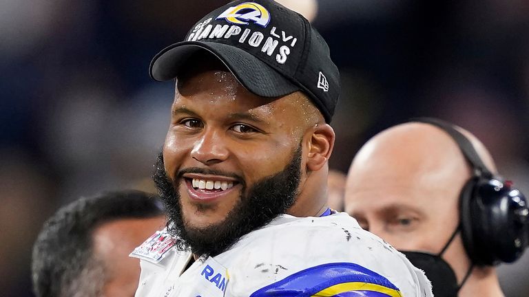 Los Angeles Rams defensive end Aaron Donald (99) smiles while on stage during the Vince Lombardi trophy presentation after the NFL Super Bowl 56 football game Sunday, Feb. 13, 2022, in Inglewood, Calif. (AP Photo/Steve Luciano)