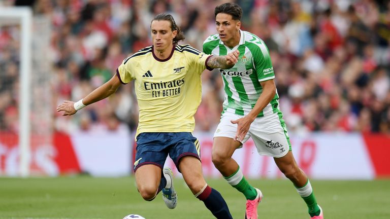 Riccardo Calafiori challenges for the ball against Real Betis