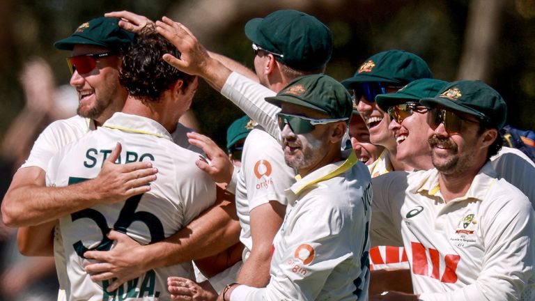 Australia congratulate Mitchell Starc after a wicket against Bangladesh on a wild first day of the second Test in Mackay