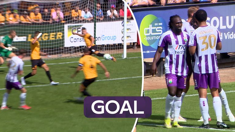 Kabongo Tshimanga finally manages to squeeze the ball over the Cambridge goal-line after the ball was cleared off the line twice before that by the home side.